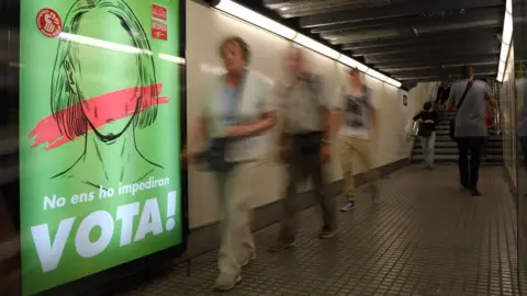 AFP A poster in the Barcelona metro reads "They won't stop us voting!"