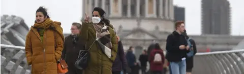 EPA People in masks walking in London