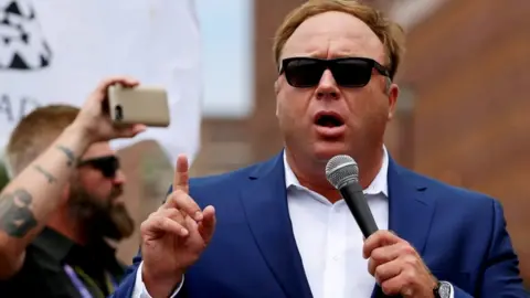 Reuters Alex Jones speaking outside of a Trump campaign event