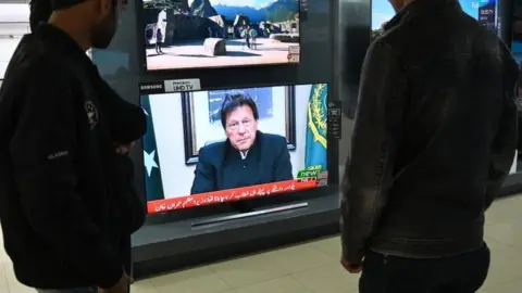 AFP Pakistani people watch the television as Prime Minister Imran Khan speaks to the population about the suicide bombing in Indian-administered Kashmir that happened on February 14, in Islamabad on February 19, 2019