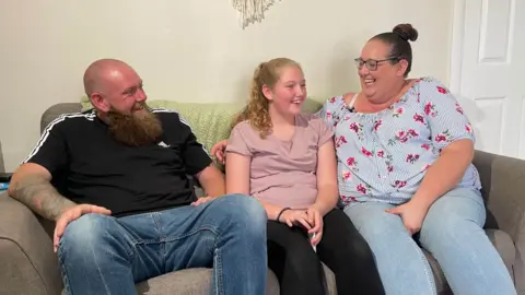 BBC Maisie sat at home with her parents