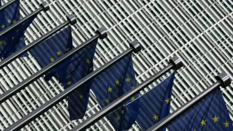 Getty Images Flags of the European Union flutter at the entrance of the European Commission's Berlaymont building at the EU headquarters in Brussels