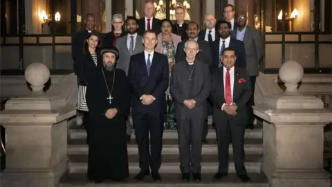 Getty Images Foreign Secretary Jeremy Hunt (front row, second left), the Archbishop of Canterbury Justin Welby (front row, second right) are joined by other Christian leaders including Archbishop Angaelos of the Coptic Orthodox Church of Britain (left), and dignitaries and politicians with survivors of Christian persecution