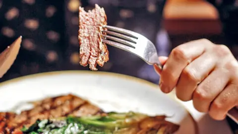 Getty Images Piece of meat on a fork