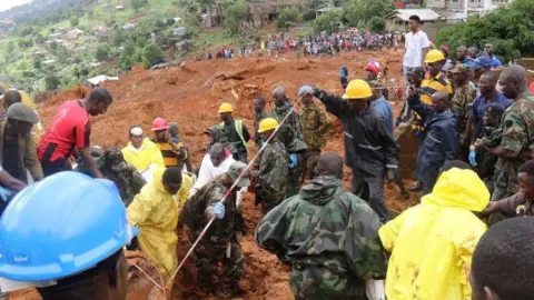 Reuters Rescue workers search for survivors after a mudslide in Regent, Sierra Leone. 14 April 2017