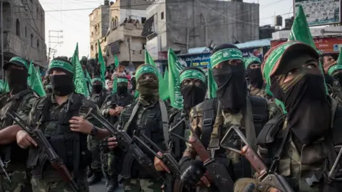 Getty Images Hamas militants are seen during a military show in Gaza City in 2017