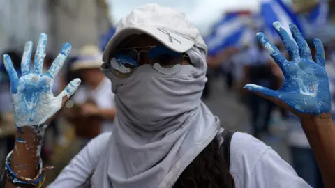 AFP A Nicaraguan protester marks 100 days since the demonstrations began