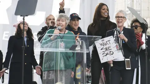 Getty Images Reddy with celebrities including Jamie Lee Curtis at a Women's March in 2017