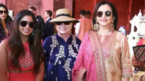 Reuters Former US Secretary of State Hillary Clinton poses with Isha Ambani (L) daughter of Mukesh Ambani, Chairman of Reliance Industries, and his wife Nita Ambani at Swadesh Bazaar, a curated showcase of traditional Indian crafts and art forms, in Udaipur, in the desert state of Rajasthan, India, December 9, 2018.