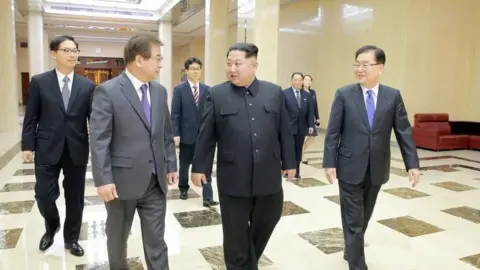 EPA Kim Jong-un (4R) with the South Korea delegation in Pyongyang (5 March 2018)