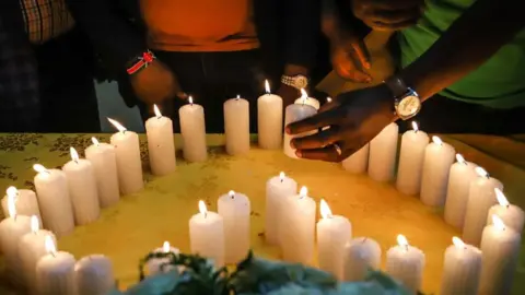 AFP Relatives of Kenyan victims light candles arranged in a heart shape during a memorial service at the Kenyan Embassy in Addis Ababa on 16 March 2019.