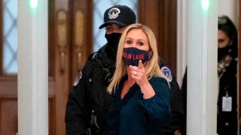 Getty Images Marjorie Taylor Greene goes through security at Congress