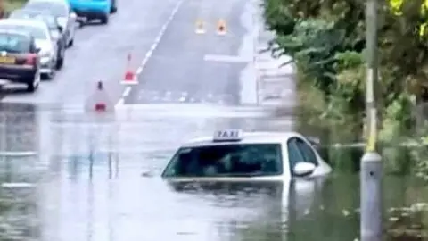 William Waiting Taxi in floods