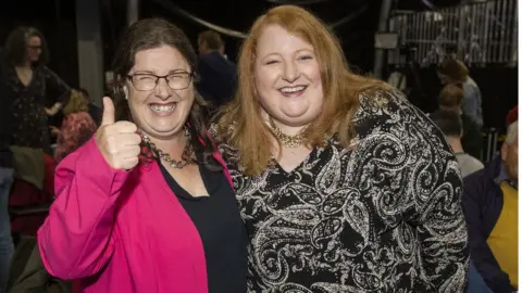Liam McBurney Kellie Armstrong celebrating with Alliance Party leader Naomi Long after she was the first MLA elected in Northern Ireland's historic election
