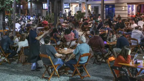 Getty Images Customers enjoy a bar in Tijuca neighbourhood on the second day after the opening of bars and restaurants