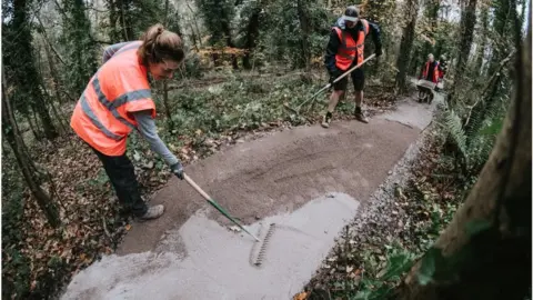 Ride Bristol Volunteers laying a new surface on a mountain bike trail at Ashton Court in Bristol