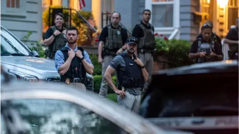 Getty Images Police oversee protesters gathered outside a judge's home last summer