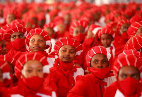Reuters Members of the congregation dressed in matching red.