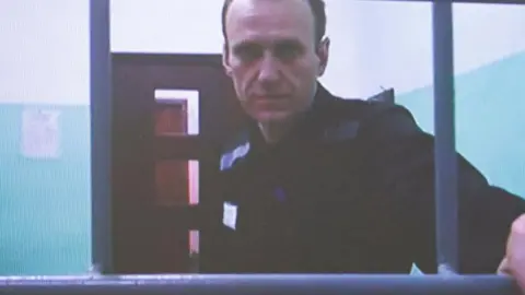 REUTERS/Yulia Morozova Alexei Navalny appears on a screen via video link from the IK-6 penal colony in the Vladimir region, during a court hearing to consider an appeal against his sentence in the criminal case on numerous charges, including the creation of an extremist organization, in Moscow, Russia September 26, 2023