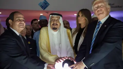 EPA Egyptian President Abdul Fattah al-Sisi, Saudi Arabia's King Salman and US President Donald Trump place their hands on a globe at the World Center for Countering Extremist Thought in Riyadh, Saudi Arabia, 21 May 2017