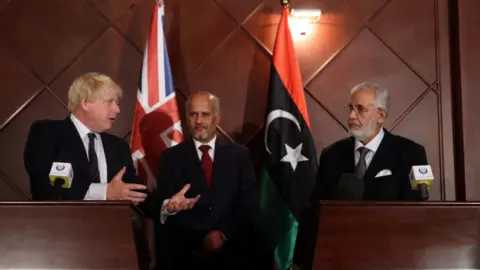 Getty Images Boris Johnson (L) speaks during a press conference with Mohamed al-Taher Siala (R), Foreign Minister of the UN-backed Libyan Government of National Accord