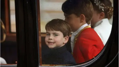 Reuters Prince Louis, Page of Honour Prince George and Princess Charlotte of Wales depart the Coronation service of King Charles III and Queen Camilla