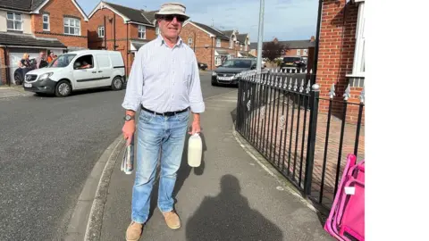 Melvyn Bull passes the 'cross the road' fundraiser in Shields Road, Hedon