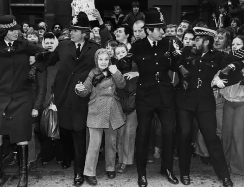 Getty Images Crowds outside Dewsbury Magistrates Court