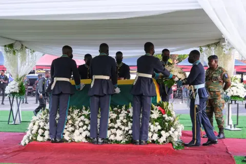 Reuters Soldiers tend to Atsu's coffin at the state-assisted funeral.