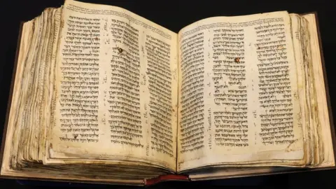 Reuters The Codex Sassoon, the oldest most complete Hebrew Bible, on display at Sotheby's in New York (15 February 2023)