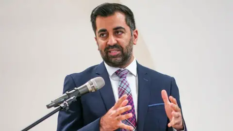 PA Media First Minister Humza Yousaf speaking during an anti-poverty summit in Edinburgh