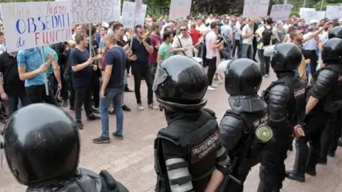 EPA People protest in front of Moldova's parliament in Chisinau. Photo: 7 June 2019