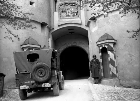 Getty Images A French soldier guards the entrance to the castle in Sigmaringen, 23 April 1945