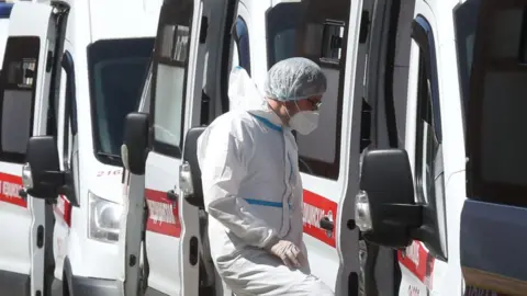 Getty Images A medical worker enters an ambulance parked outside admissions at Pokrovskaya Municipal Hospital, St Petersburg