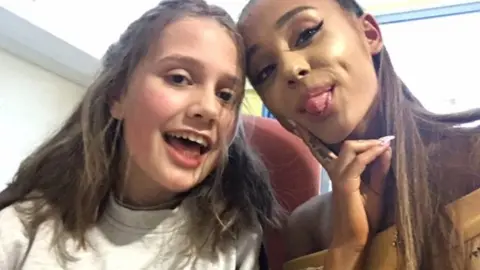 PA Ariana Grande with one of the victims of the Manchester attack