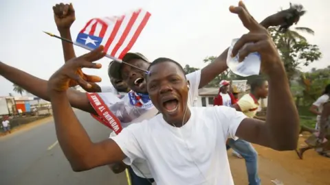 EPA Liberians cheer as they stand in line to enter the inauguration off the President-elect, George Weah, at the Samuel Kanyon Doe stadium, in Monrovia, Liberia, 22 January 2018.