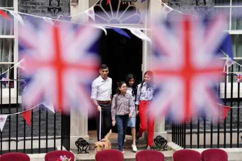 PA Media Prime Minister Rishi Sunak with dog Nova and wife, Akshata Murty, with children Krishna Sunak (left) and Anoushka Sunak before hosting a Coronation Big Lunch in Downing Street, London, for volunteers, Ukrainian refugees in the UK, and youth groups