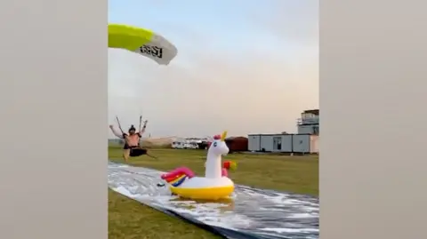 Skydiver lands on inflatable