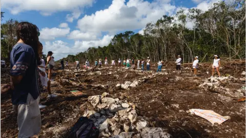 AFP People stand in the cut down part of the rainforest where the Tren Maya is being built