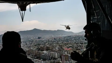 Getty Images Members of the 777 Special Mission Wing secure and transport the Chief of General Staff of the Armed Forces Gen. Mohammad Yasin Zia, to Camp Morehead, near Kabul