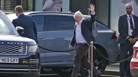 PA Media Former Prime Minister Boris Johnson arrives at Gatwick Airport in London, after travelling on a flight from the Caribbean, following the resignation of Liz Truss as Prime Minister.