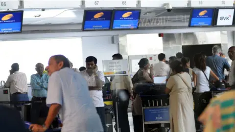 Getty Images Jet Airways Pilots on Mass Sick Leave - Passengers at Mumbai Domestic Airport - Mobile Phones - Luggage - Business travellers run helter skelter as several Jet Airways flights were cancelled during peak departure hour - Flights displays went blank at Mumbai's domestic terminal 1.