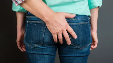 Getty Images Woman's bottom being touched