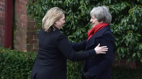 Getty Images Karen Bradley greets Theresa May at Stormont in February 2018