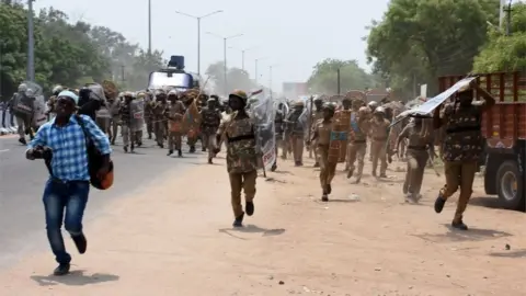 AFP Indian police officials charge towards protestors in the southern Indian city of Tuticorin some 600 kilometres (375 miles) south of Chennai on May 22, 2018, during a protest rally held to demand the closure of a copper factory due to pollution concerns