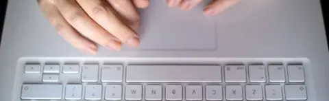 PA hands using a laptop keyboard