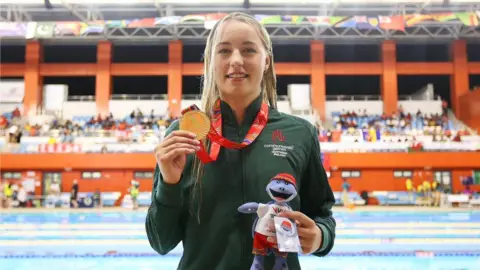 Commonwealth Youth Games Ellie McCartney holding her gold medal