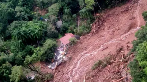 Brazilian Air Force View of a house in a flooded area taken from a helicopter