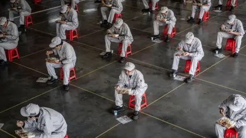 Getty Images Workers keeping a distance from each other during their lunch break