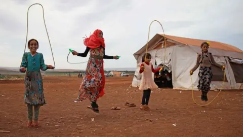 AFP Syrian children at a makeshift school in a camp for displaced people in Atmeh, Idlib province (1 October 2018)